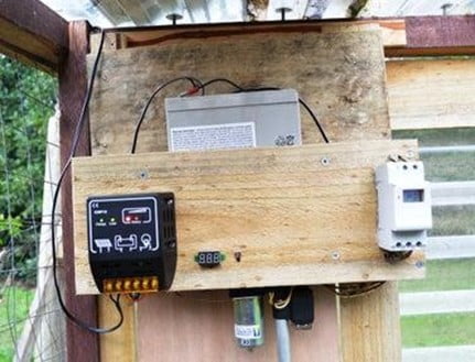 solar regulator on the wall of the chicken coop