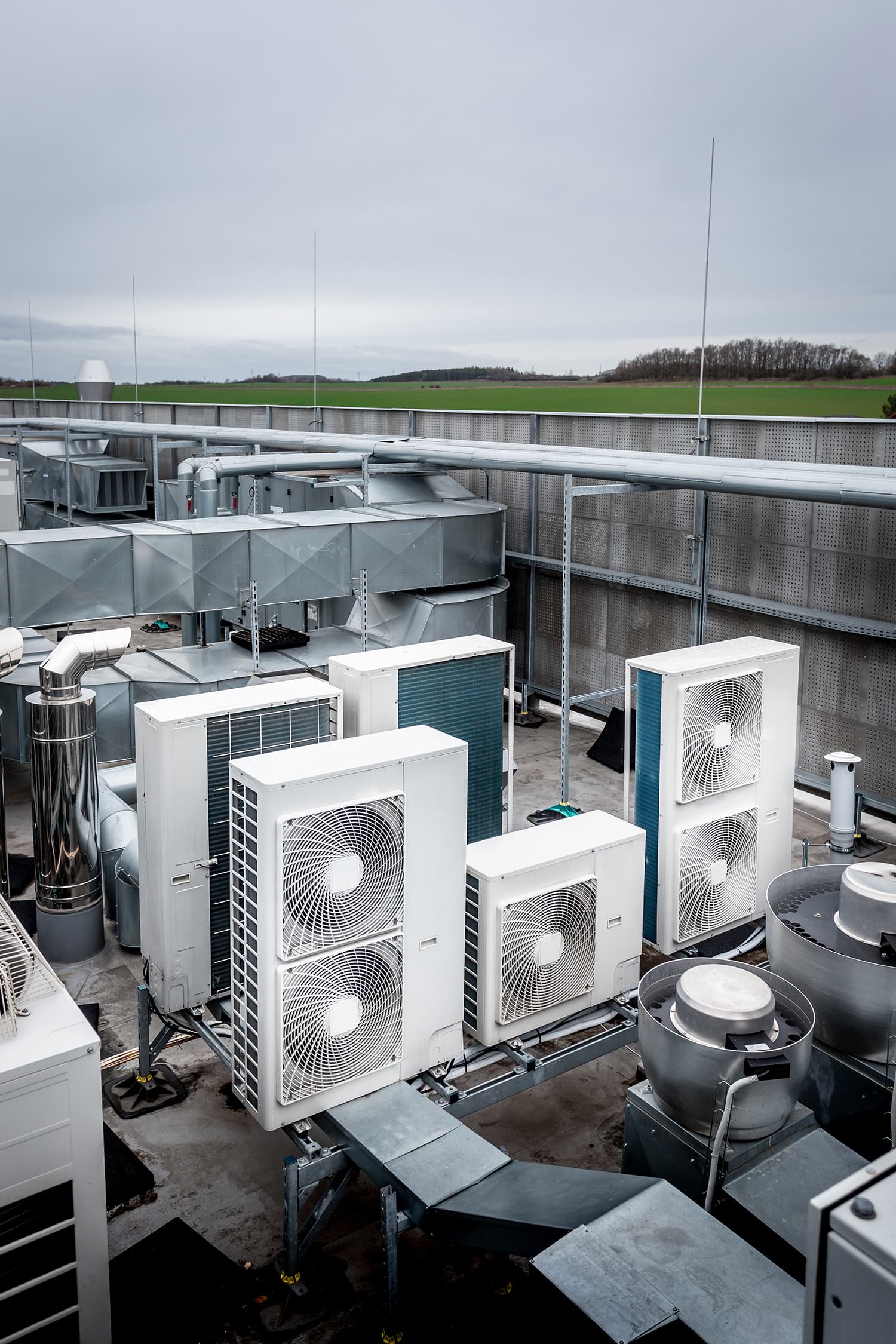Square air-conditioning units on the roof with round fan grills