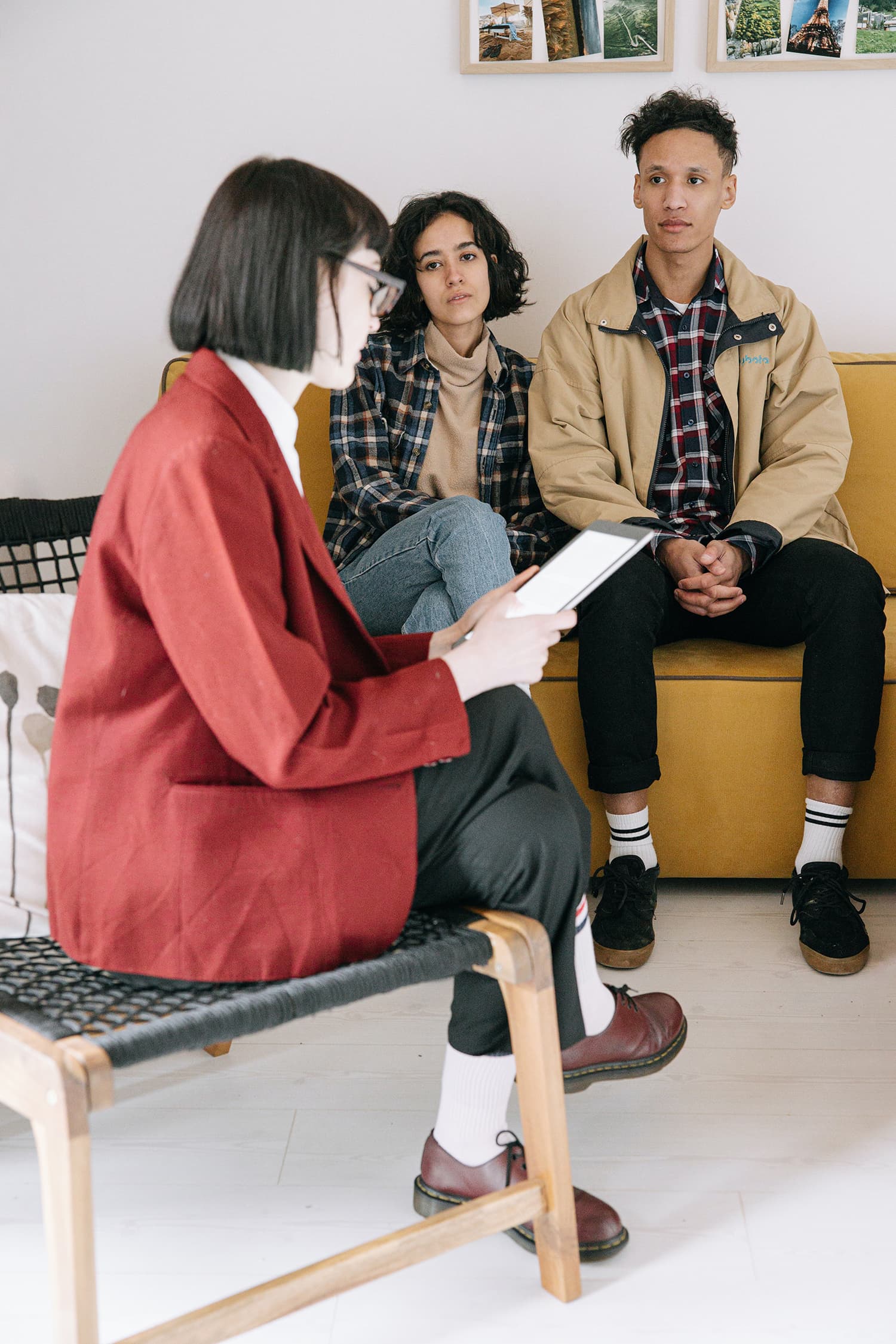 Man in Red Coat Sitting Beside Woman in Brown Coat